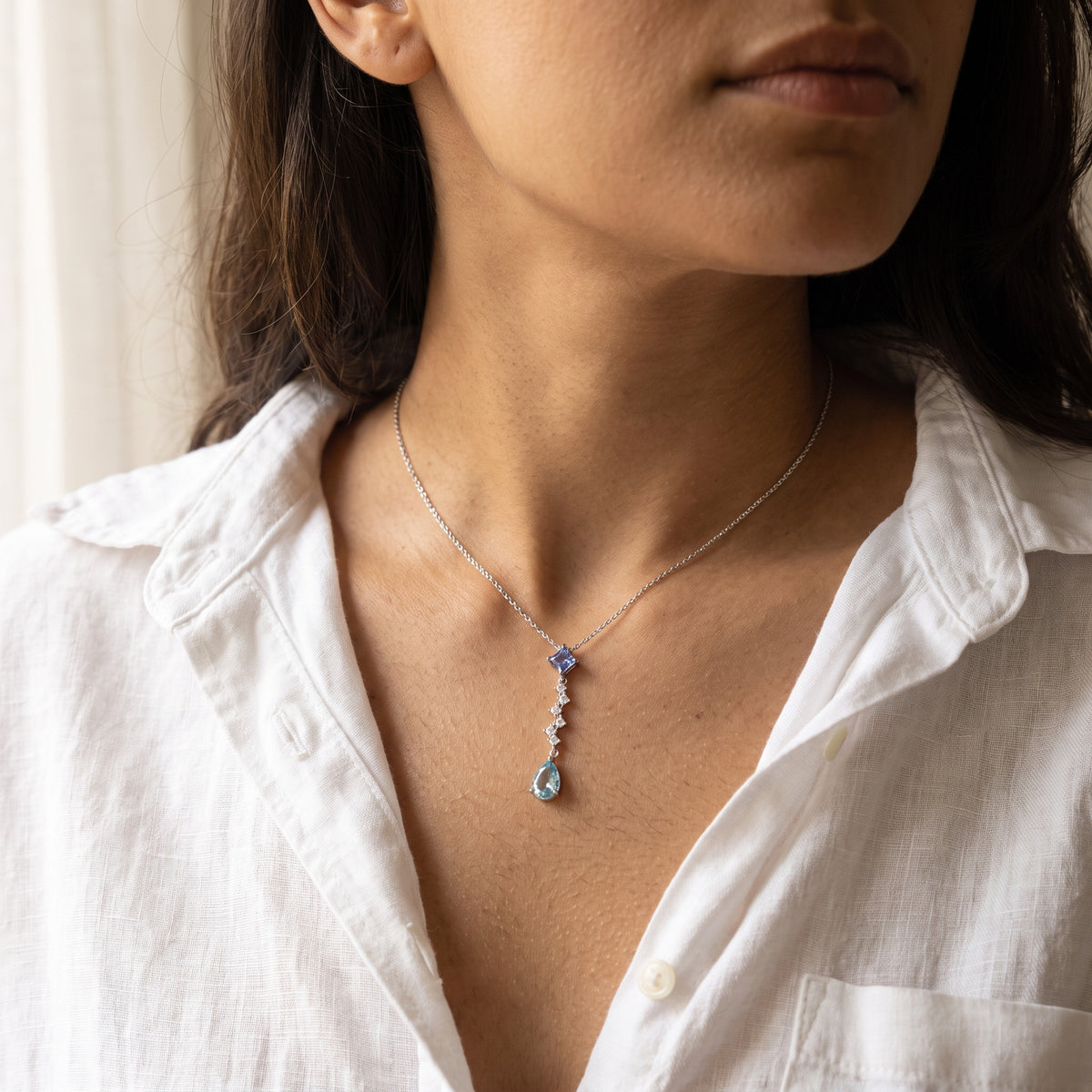 Woman wearing the Ariel Ocean Tear necklace