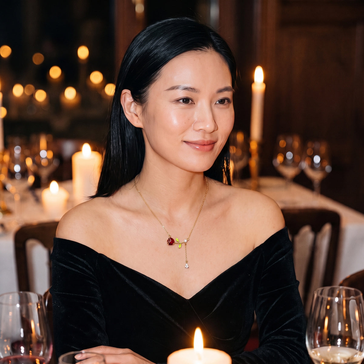 Woman in a black velvet dress wearing the Belle Pearl Rose necklace