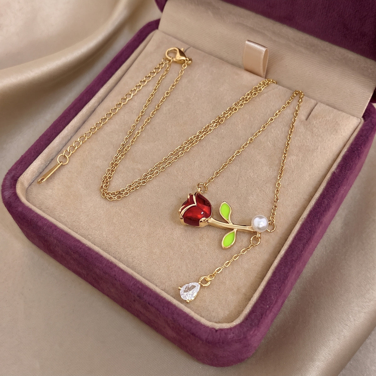 The Belle Pearl Rose necklace in the Storyelle plum velvet gift box