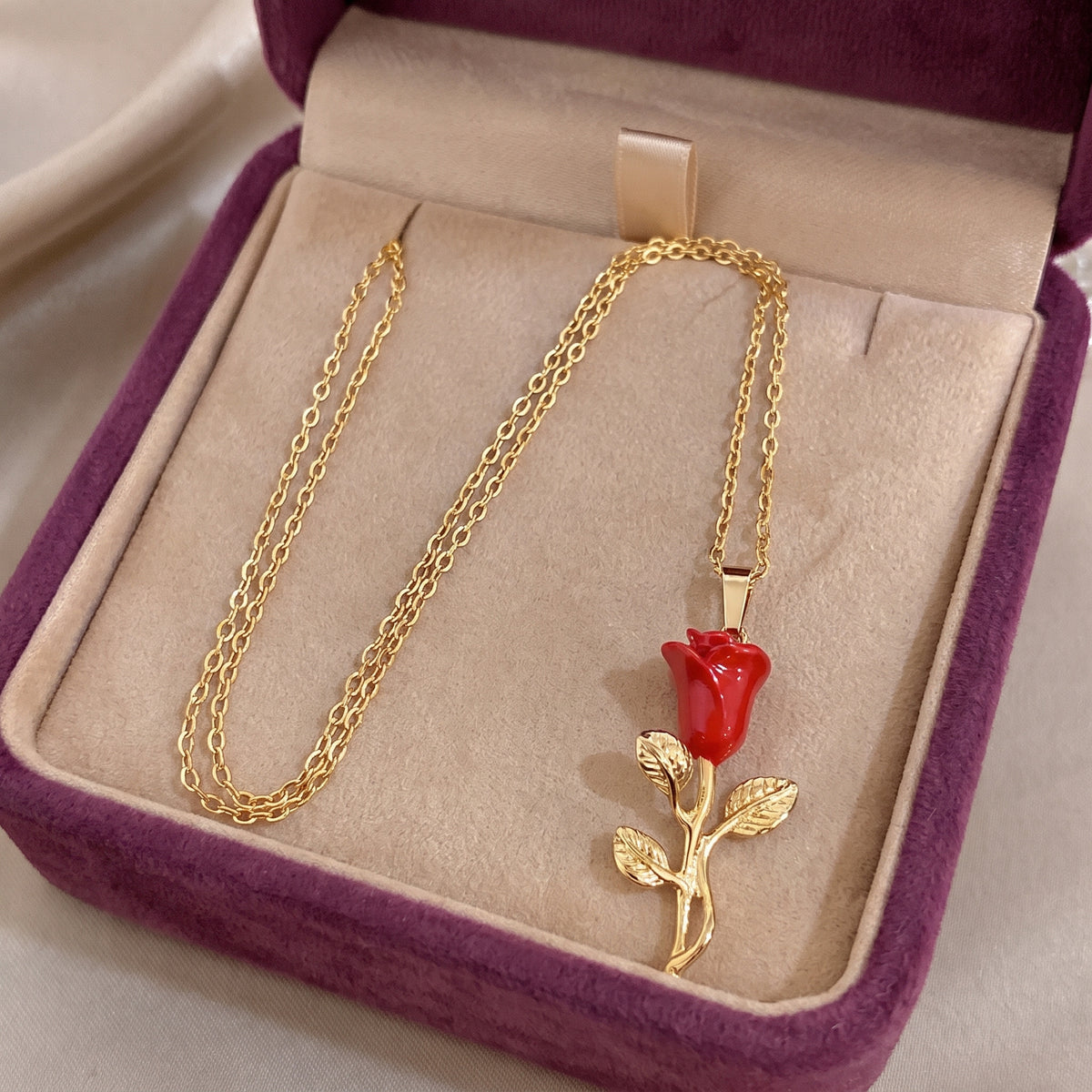The Belle Enchanted Rose necklace in the Storyelle plum velvet gift box
