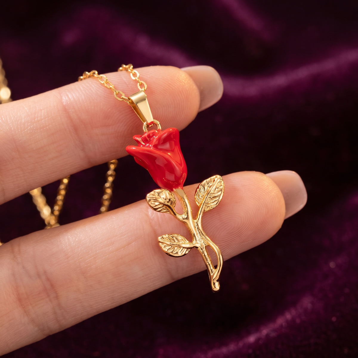 Close-up of the glossy red enamel rose pendant