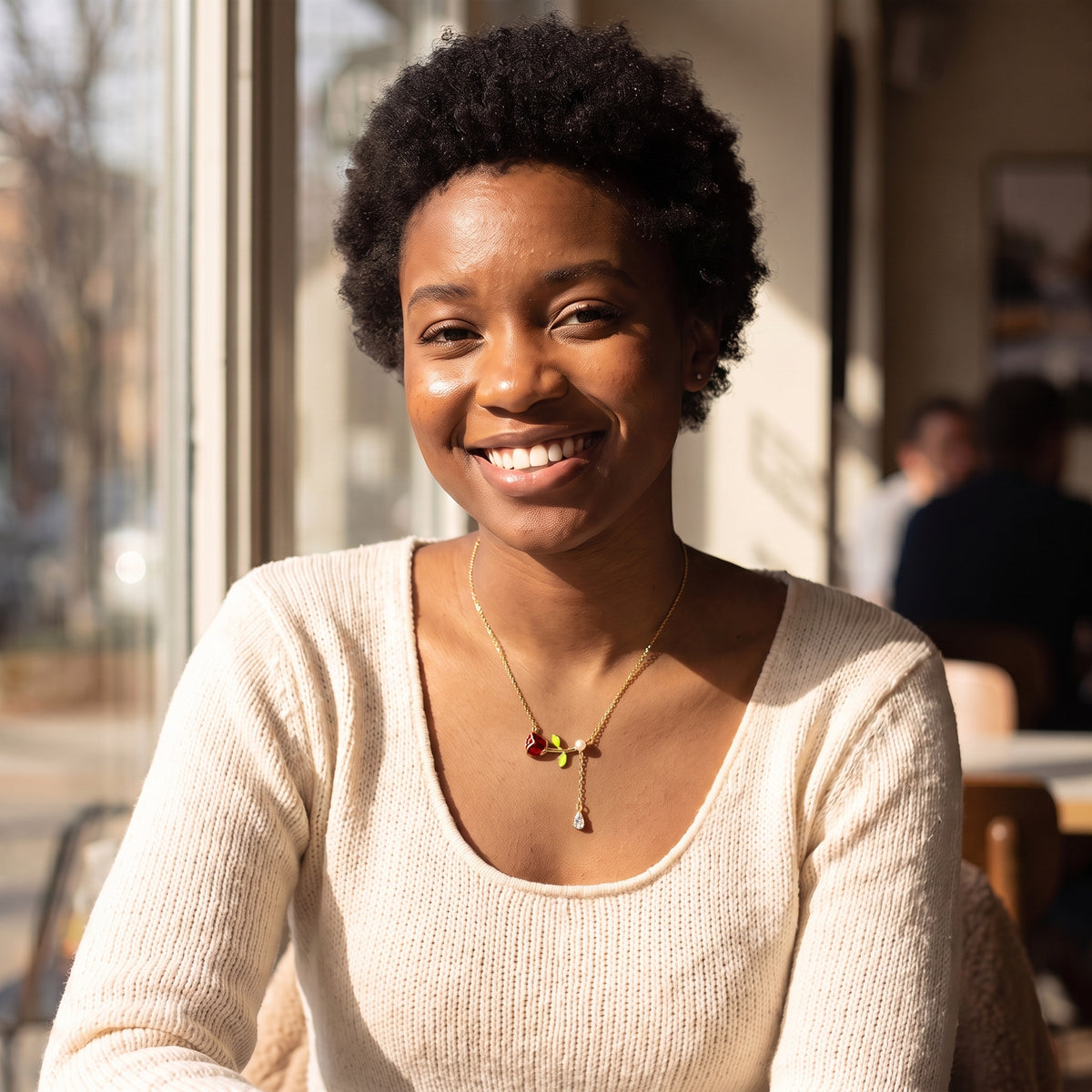 Smiling woman wearing the Belle Pearl Rose necklace