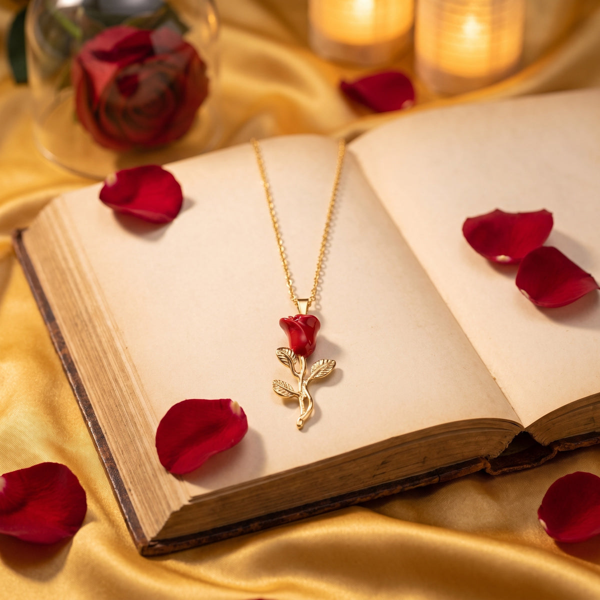 The Enchanted Rose necklace on an open antique book with red rose petals