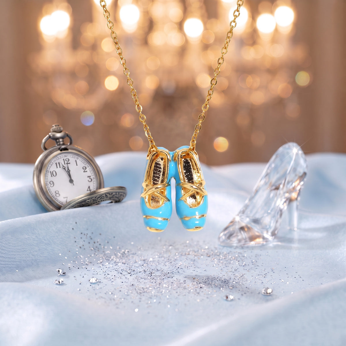 The “Cinderella” Blue Ballet Gold Necklace on ice-blue satin with a glass slipper and a pocket watch