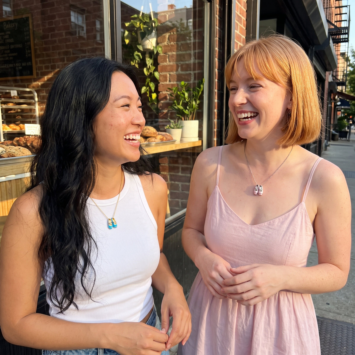 Best friends wearing the blue and pink ballet slipper necklaces