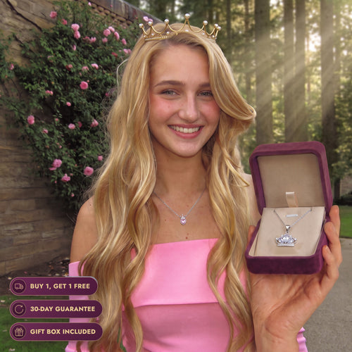 Real life Aurora by a stone cottage with pink roses in the forest, holding the Storyelle gift box and wearing the Rose Crown necklace, buy 1 get 1 free, 30-day guarantee, gift box included