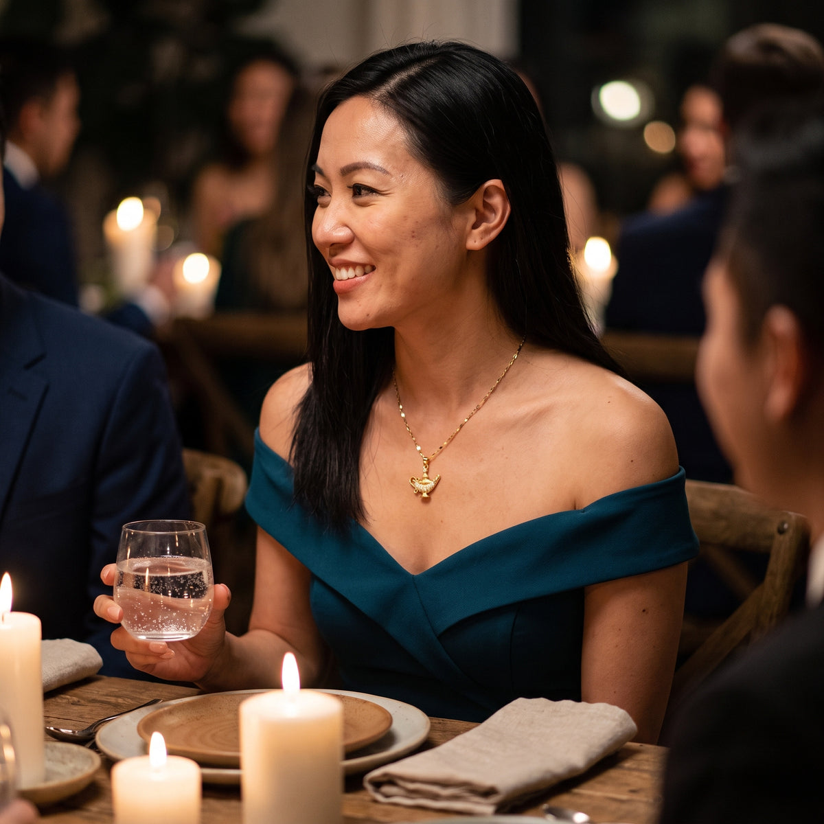Woman in a teal evening dress wearing the Starlight Lamp necklace
