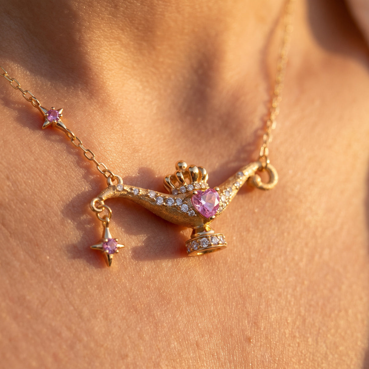 Close-up of the Wish Lamp pendant with its pink heart and tiny crown