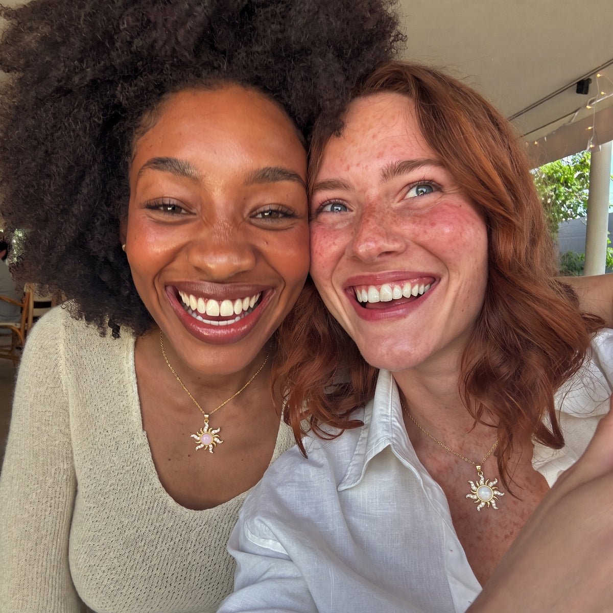 Best friends wearing the Rapunzel Rose Opal and Moonlight Opal sun necklaces