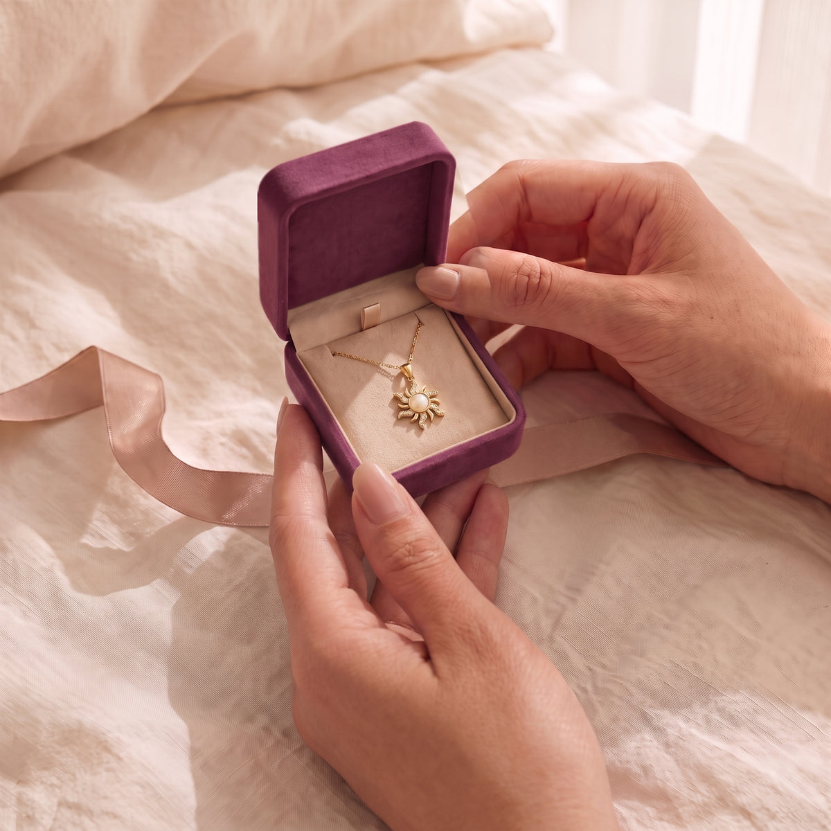Hands opening the Storyelle plum velvet gift box with the Rapunzel Moonlight Opal necklace