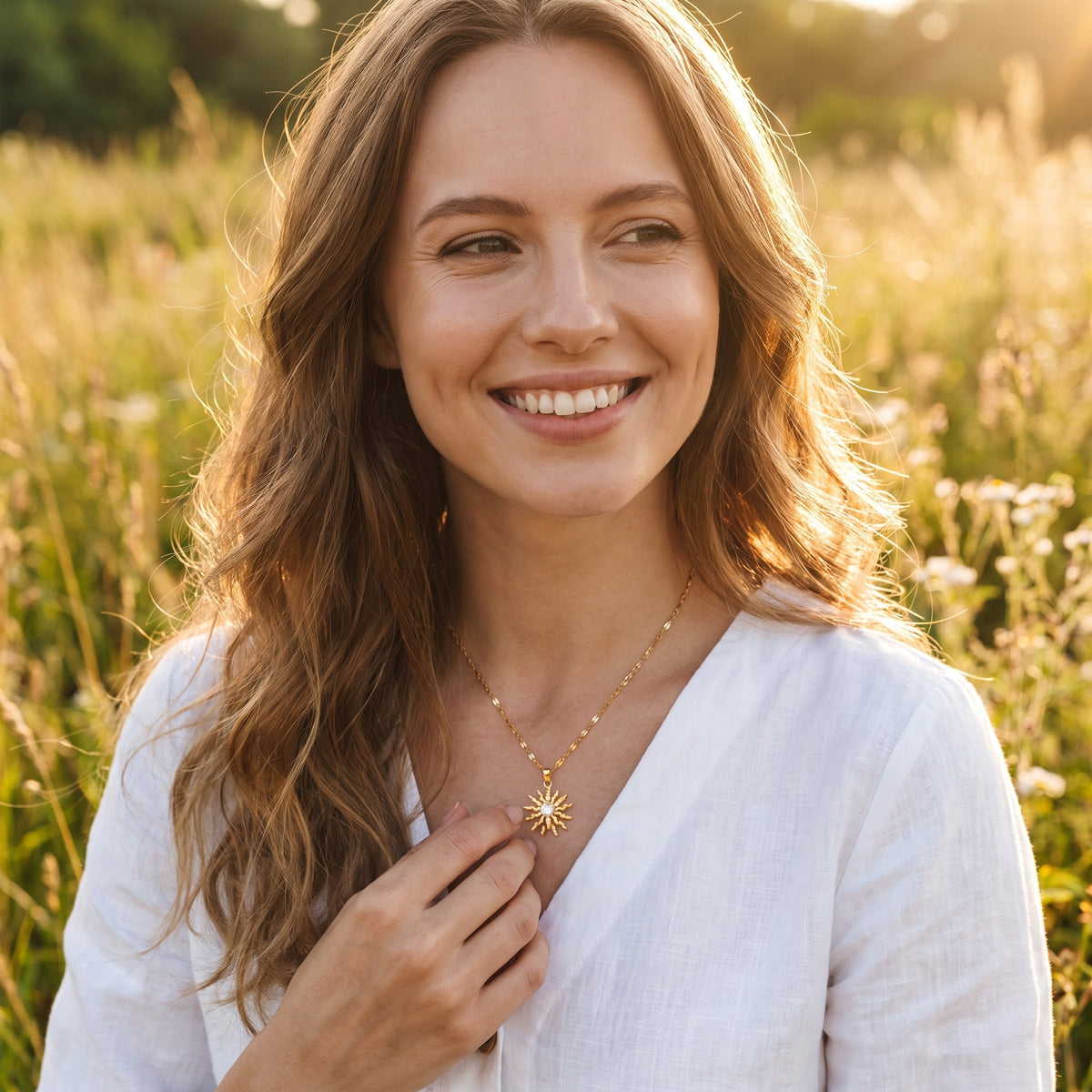 Smiling woman wearing the Rapunzel Spinning Gold sun necklace