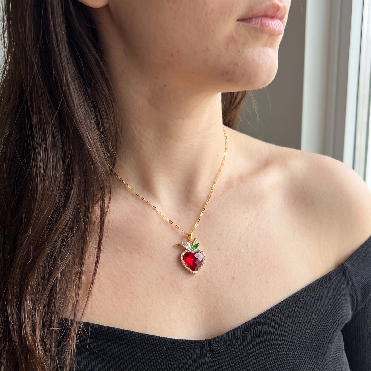 Woman wearing the Snow White Crimson Heart necklace