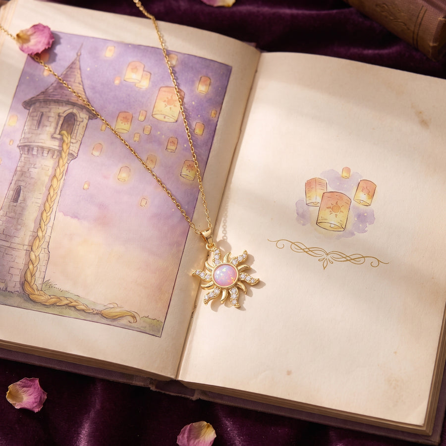 The Rapunzel Rose Opal sun necklace on an open fairytale storybook