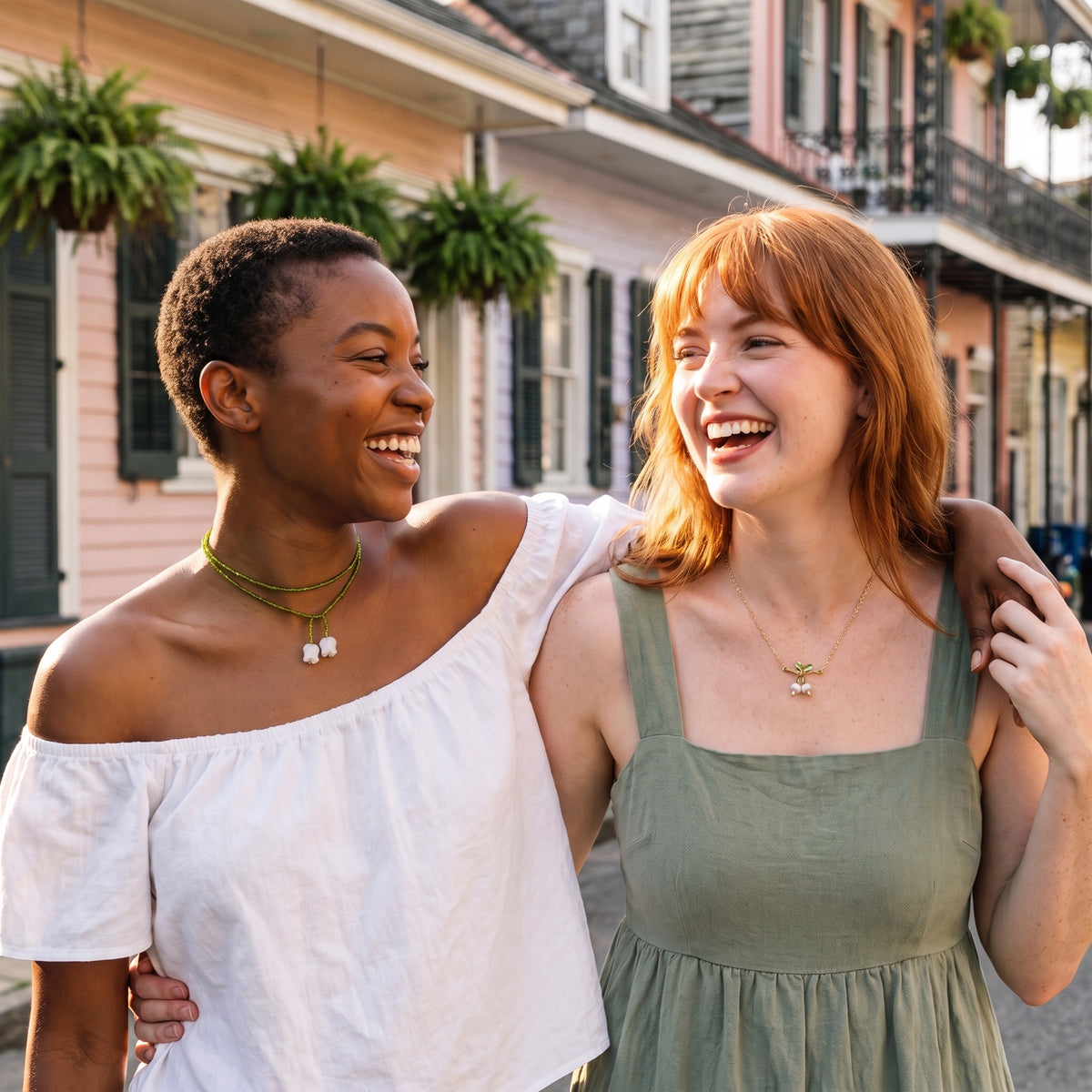 Best friends wearing the Emerald Lily and Golden Lily necklaces