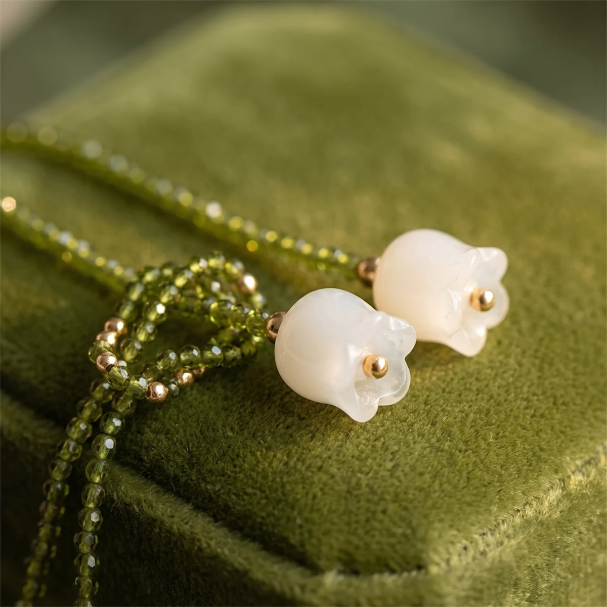 Close-up of the milky white lily blooms and green crystal beads