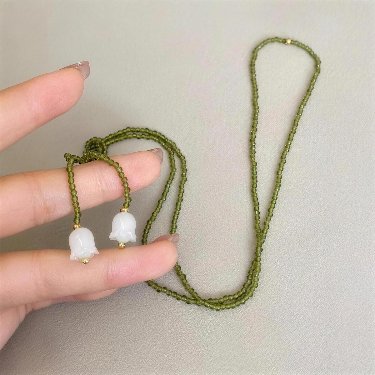The Emerald Lily lariat shown at its true size